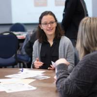 Attendees discuss a topic at a round table.